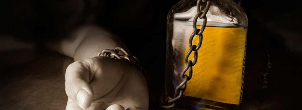 man chained to alcohol